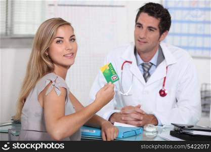 Teenager showing French health insurance card