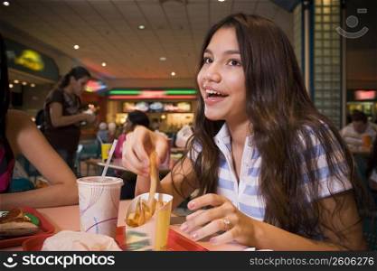 Teenager sitting in mall food court