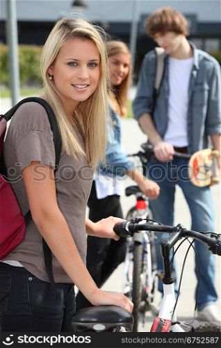 Teenager stood by bicycle