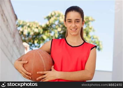 Teenager student girl with a basket ball outdoor