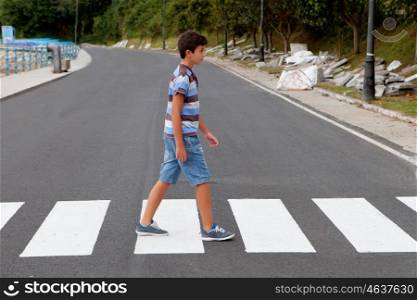 Teenager through a zebra crossing in his town