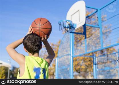 Teenager throwing a basketball into the hoop