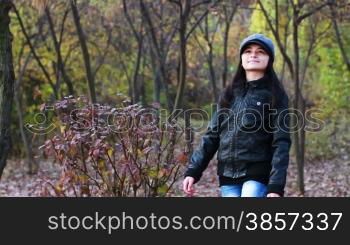 Teenager walking through the woods in autumn season