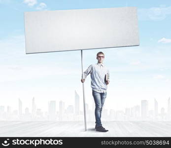 Teenager with banner. Young man against city background holding blank banner. Place for text