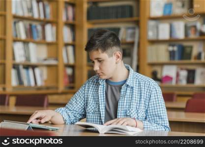 teenager with book using tablet