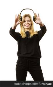 Teenager young grunge woman holding trendy headphones with golden spikes. Female enjoying her passion.. Teenage woman holding headphones