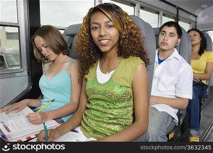 Teenagers Doing Homework While Riding School Bus