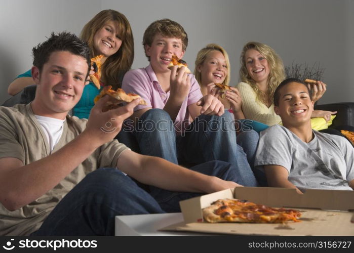 Teenagers Having Fun And Eating Pizza