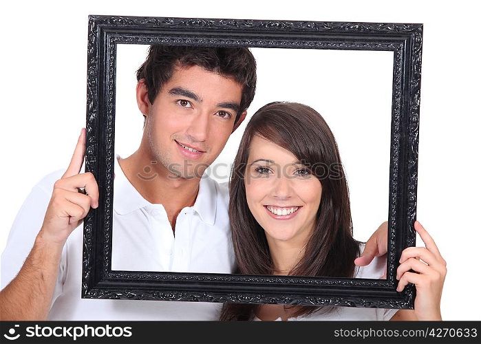 Teenagers holding photo frame