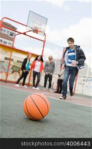 Teenagers in basketball court