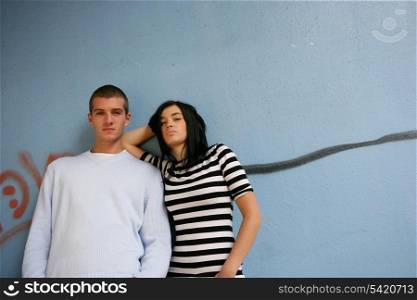 Teenagers in front of graffiti wall
