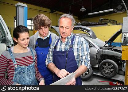 Teenagers in professional training with garage woner