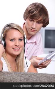 Teenagers listening to CD&acute;s on headphones