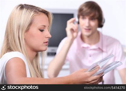 Teenagers listening to music on CD