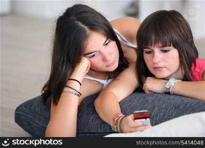 Teenagers looking at a mobile phone