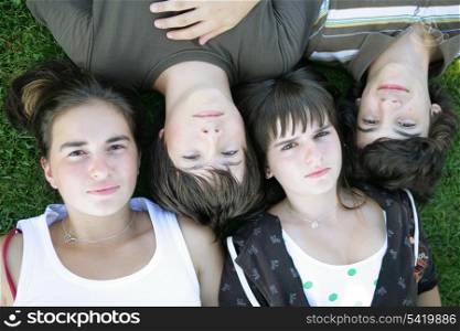 Teenagers lying in the grass