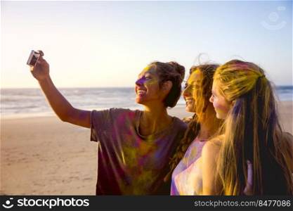 Teenagers making a selfie after playing with colored powder