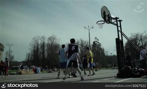Teenagers playing basketball in a city park at Moscow spring festival in Luzhniki on May 6, 2013 in Moscow, Russia.