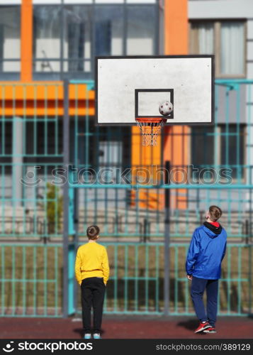 teenagers playing basketball on the playground . teenagers playing basketball