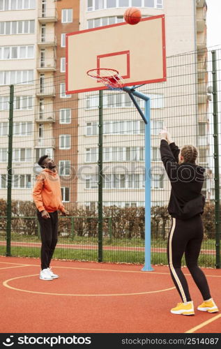 teenagers playing basketball outdoors 5