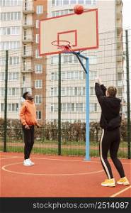 teenagers playing basketball outdoors 5