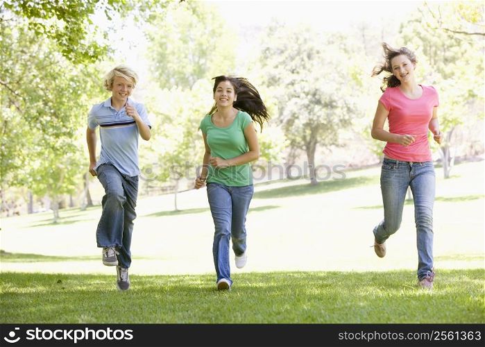 Teenagers Running Through Park