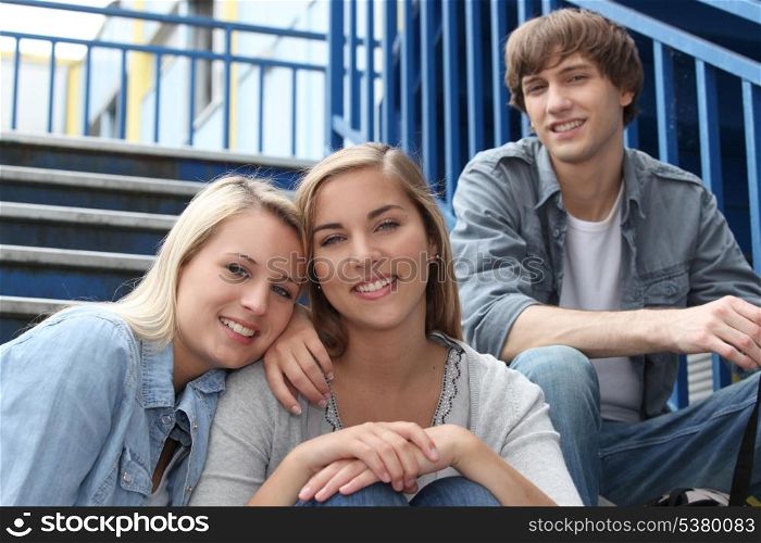 Teenagers sat on the steps