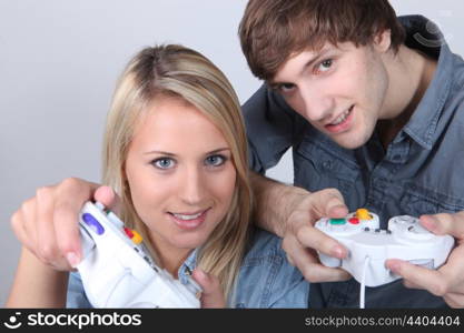 Teenagers using handsets for a games console