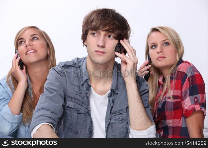 Teenagers using mobile telephones