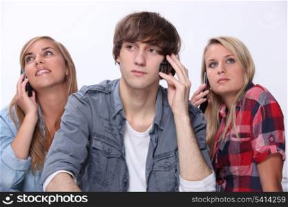 Teenagers using mobile telephones
