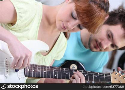 Teenagers with guitar indoors