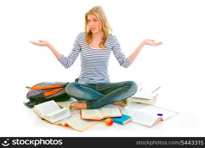 Teengirl with surprise expression on face sitting on floor surrounded by books isolated on white &#xA;