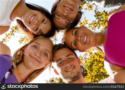 Teens in a circle smiling in park leisure students friends