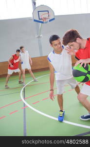 teens playing basketball