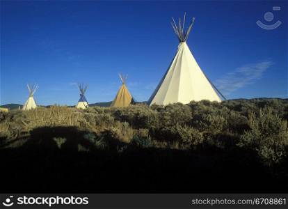 Teepees on a landscape