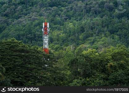 Telecommunication communication antenna tower or Mobile station receiver antenna tower with coverage the mountains forest and rainforest Background