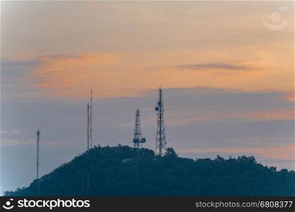 Telecommunication tower Antenna at sunset sky.