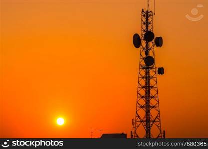 Telecommunication tower structure with sunset sky in silhouette background