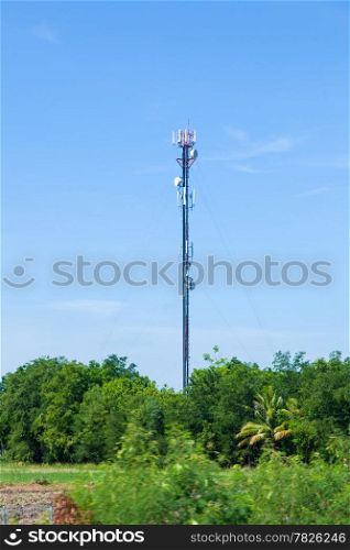 Telecommunications antenna. The station is located in an area covered with tall trees.