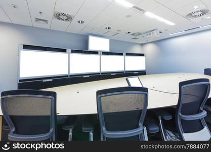 teleconferencing, video conference and telepresence business meeting room with blank screen display monitor