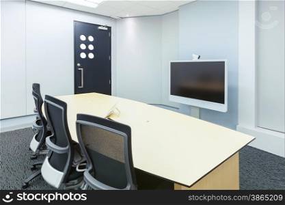 teleconferencing, video conference and telepresence business meeting room with display screen