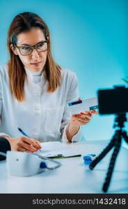 Telemedicine ? Medical doctor having a virtual conference session with patient and showing medication for therapy