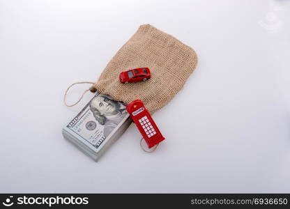 Telephone booth, car and and banknote bundle of US dollar in a sack