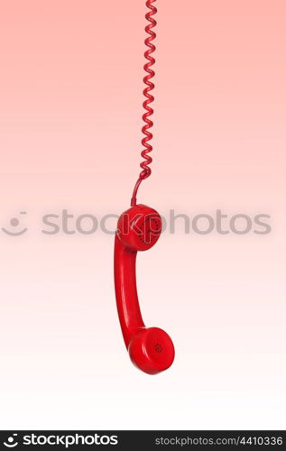 Telephone cable hanging isolated on red background