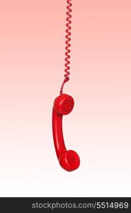 Telephone cable hanging isolated on red background