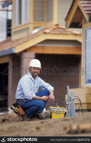 Telephone line installer working at construction site