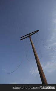 Telephone with cut cables, low angle view