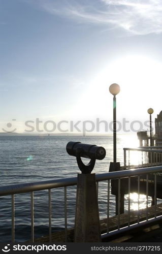 Telescope on the pier overlooking the water