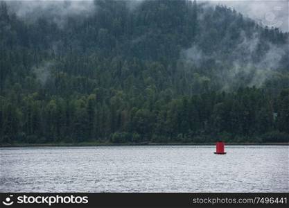 Teletskoye lake in Altai mountains, Siberia, Russia. Foggy summer morning.. Foggy Teletskoye lake in Altai mountains