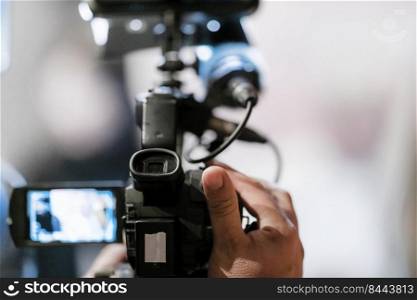 Television camera at an evening press conference 